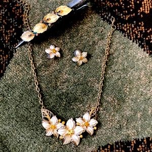 Three piece matching floral jewelry set, necklace, earrings and hair clip